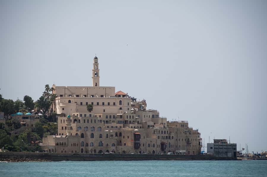 Jaffa's Timeless Tales: Legends & Labyrinths Private Tour - St. Peter’s Church and the hilltop Tel Aviv coastline contrast